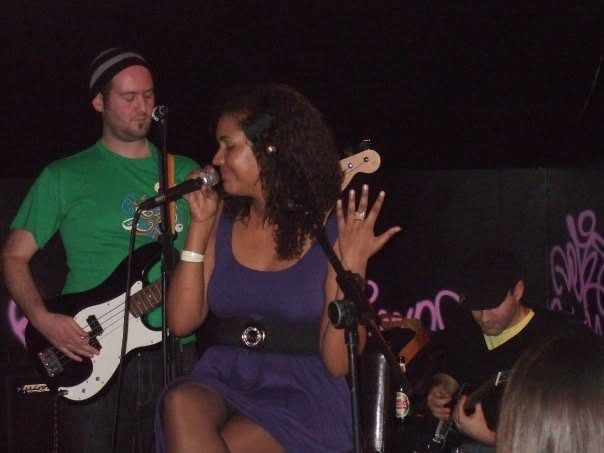 Singer in a purple dress with the bassist