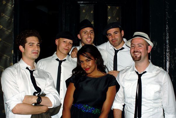 The IP Band in white shirts and black ties with LeaLea Jones in front
