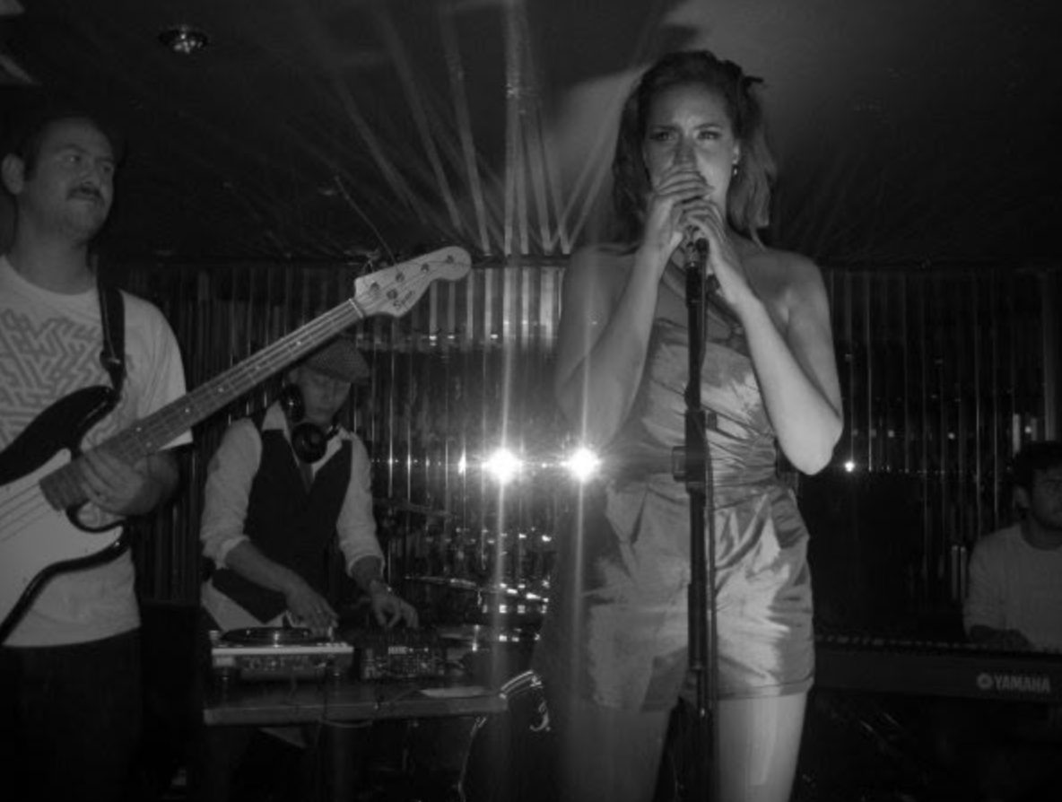 Black and white shot of the singer and band on stage