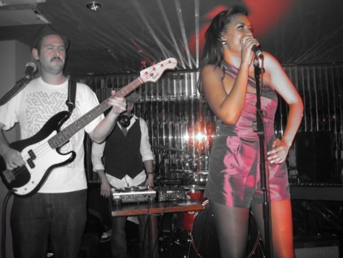 A singer fronting the IP Band in a club
