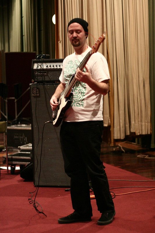 Bassist in front of an amp in the live room
