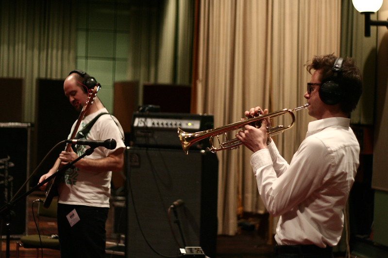 Bass and trumpet recording together in a studio live room